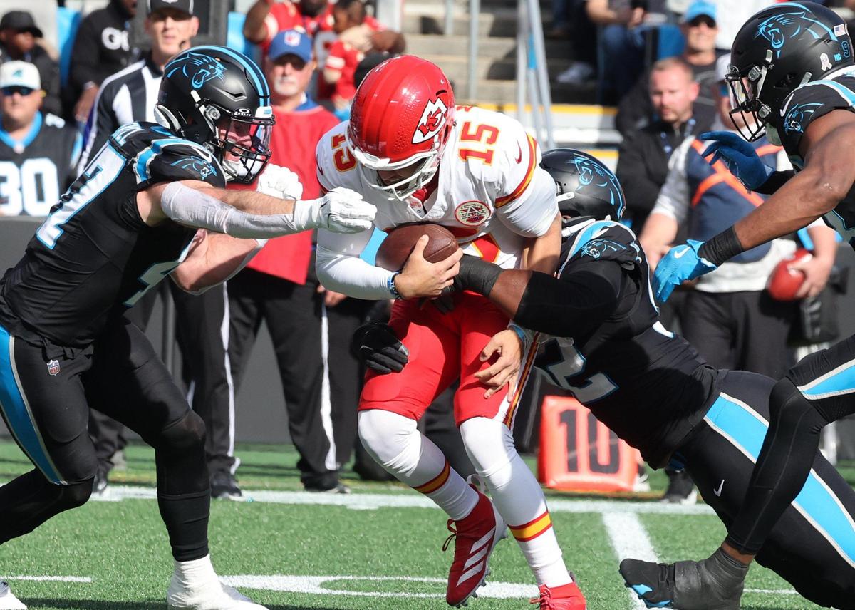 Chiefs quarterback Patrick Mahomes is tackled by Panthers Jonathan Harris, right, and Josey Jewell Sunday in Charlotte, N.C.