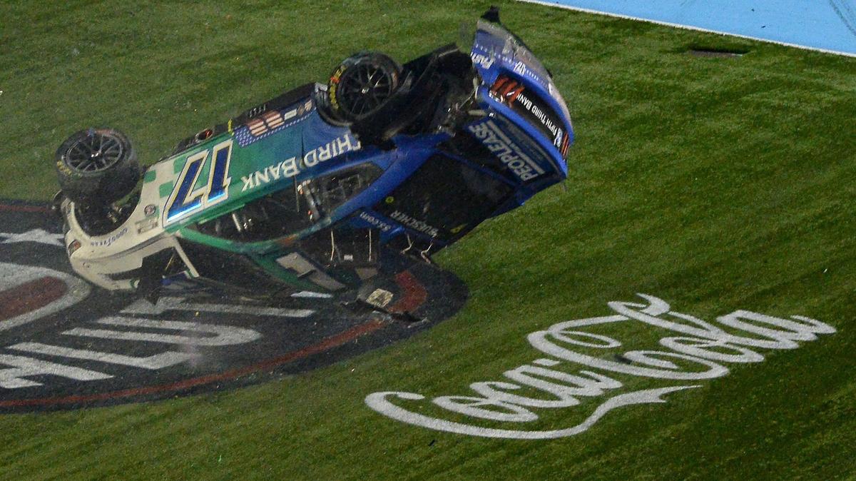 NASCAR drivers Chris Buescher’s (17) car begins to flip after he and driver Daniel Suarez (99), wrecked after crossing the start/finish line during the Coca-Cola 600 at Charlotte Motor Speedway on Sunday, May 29, 2022. Buescher would flip down the front stretch before coming to rest on the roof of the car.