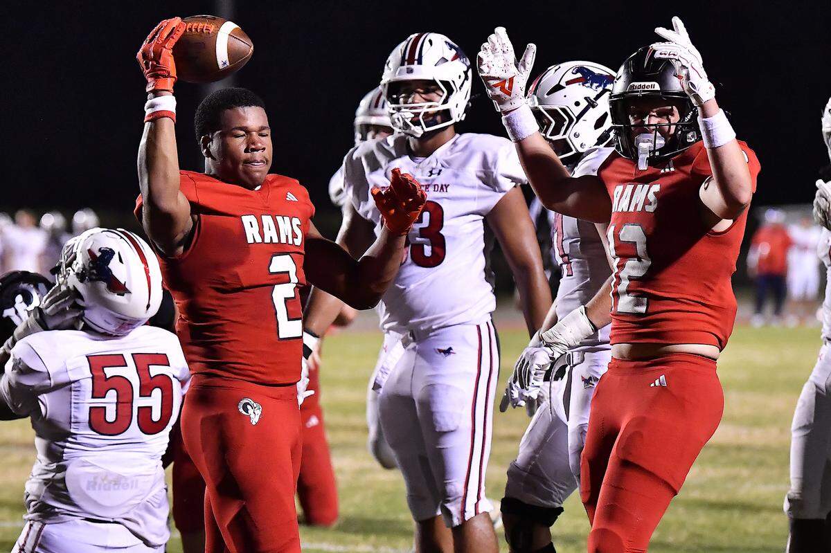 Rolesville tight end Henry Evans (12) celebrates the touchdown against Providence Day by Amir Brown (2) late in the first half. The Rolesville Rams and the Providence Day Chargers met in a non-conference football game in Rolesville, N.C. on August 29, 2025.