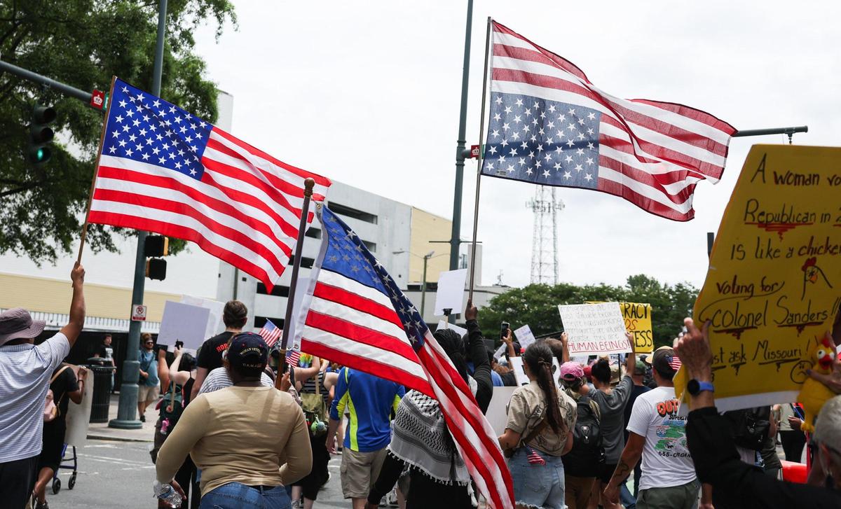 Protesters march during the No Kings protest along Tryon Street in Charlotte on Saturday, June 14, 2025.