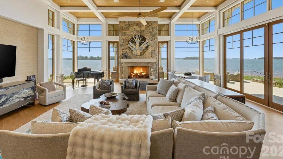 The main level of the home includes a lakeside primary suite, open gathering spaces and a chef’s kitchen that connects to outdoor living areas.