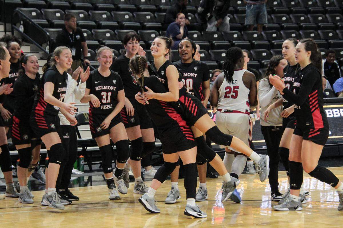 Members of the Belmont Abbey women’s basketball team celebrate after winning their conference tournament to advance to the Division II postseason.