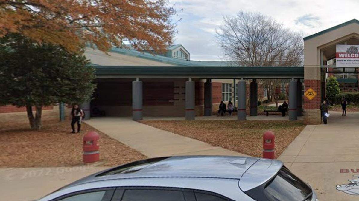 Police arrested and charged a Butler High School teacher after he left his fanny pack in the school learning center with two pistols inside, arrest records show.