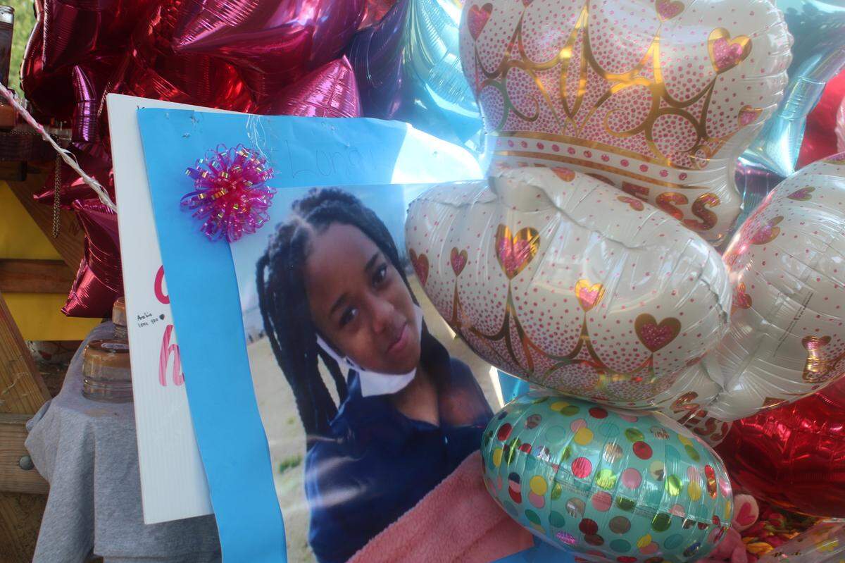 Family, friends and many others turned a picnic table into a memorial for Loyalti Allah, a 13-year-old who was fatally shot in a drive-by shooting on Icemorelee Street in Monroe, NC, on Saturday, July 24, 2021.