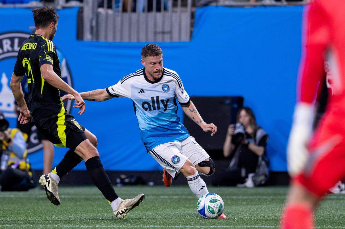 Charlotte FC midfielder Pep Biel (16) challenges Columbus Crew defender Yevhen Cheberko (21) during Saturday’s first half at Bank of America Stadium.