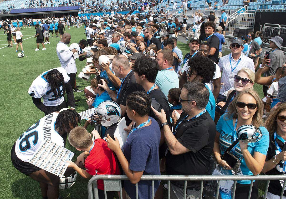 Fans, many in costume or holding up signs, celebrated the return of Panthers’ football during practice at Bank of America Stadium on Saturday, July 27, 2024 as part of the annual Back Together Saturday event. Practice, which began at 9:30 a.m., included performances by the Panthers entertainment group and activities for fans. Fans cheered on players like Bryce Young (#9), Xavier Legette (#17), Damien Lewis (#68) and head coach Dave Canales.