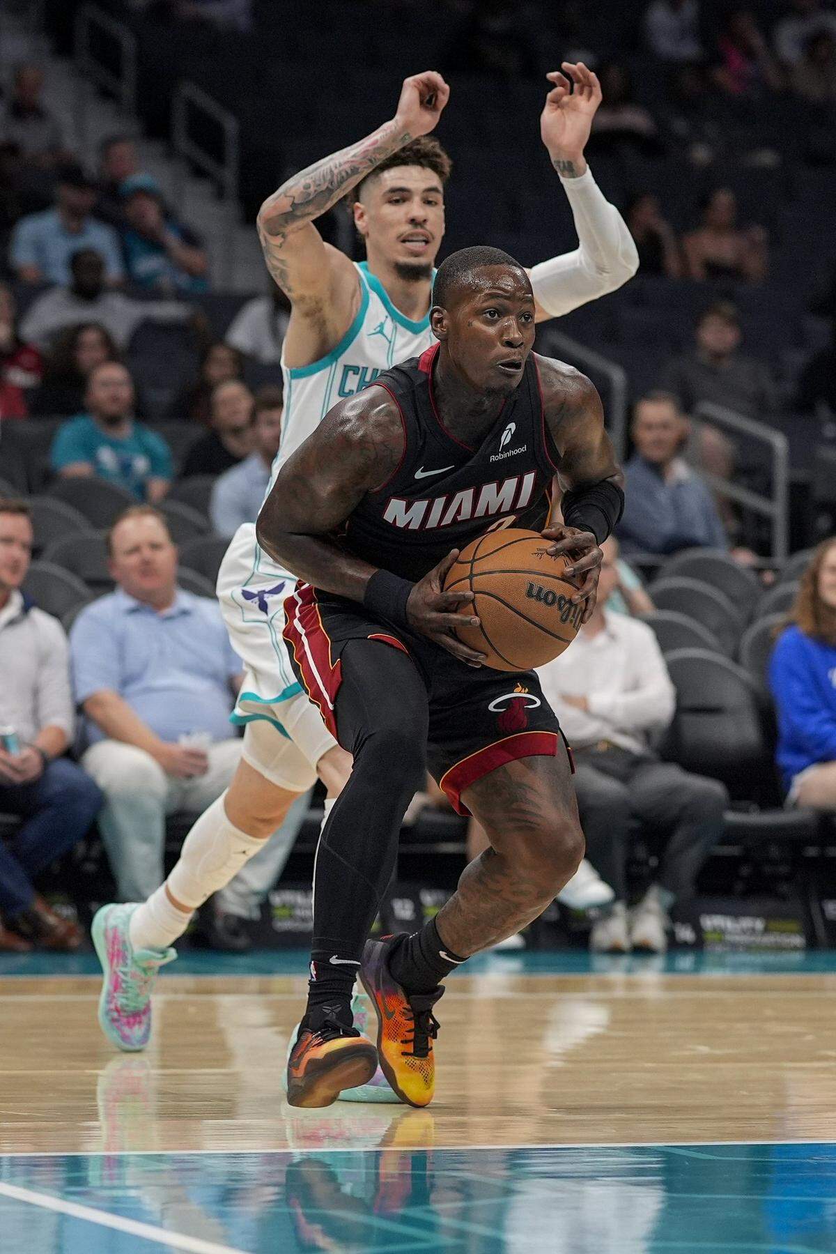 Oct 8, 2024; Charlotte, North Carolina, USA; Miami Heat guard Terry Rozier (2) passes pressured by Charlotte Hornets guard LaMelo Ball (1) during the first quarter at Spectrum Center. Mandatory Credit: Jim Dedmon-Imagn Images