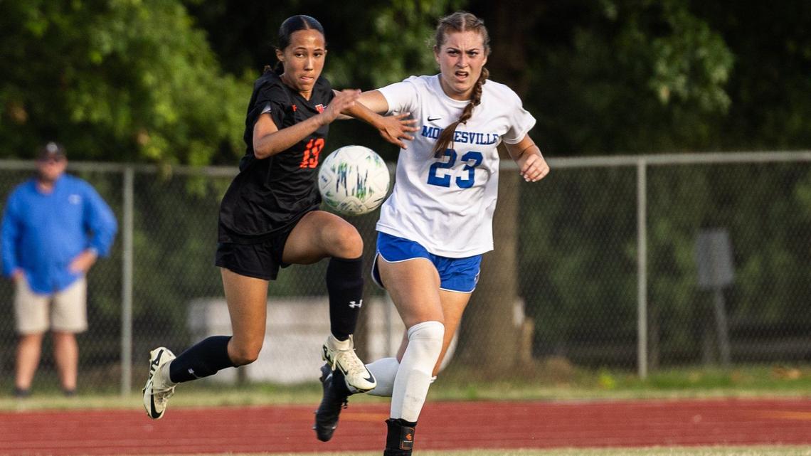 Marvin Ridge’s Jaida Savoie, left, and Mooresville’s Melaine Inman fight for the ball at Marvin Ridge High School in Waxhaw, N.C., on Tuesday, May 28, 2024.