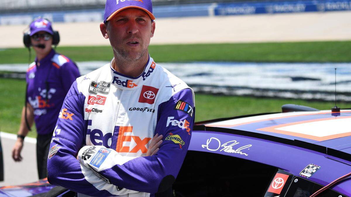 Jun 24, 2023; Nashville, Tennessee, USA; NASCAR Cup Series driver Denny Hamlin (11) waits beside his car for qualifying before the Ally 400 at Nashville Superspeedway. Mandatory Credit: Christopher Hanewinckel-USA TODAY Sports