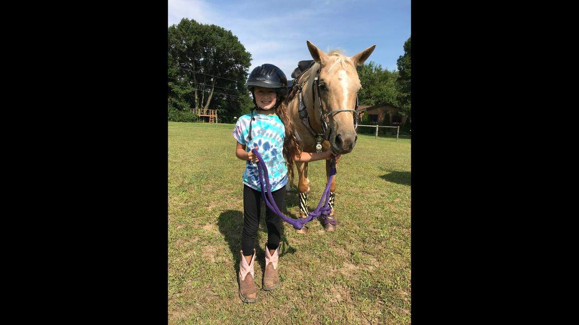 In an undated photo released by authorities, Madalina Cojocari is shown with a horse. The 11-year-old Cornelius girl went missing before Thanksgiving 2022 and her mother and stepfather were arrested for not reporting her disappearance.