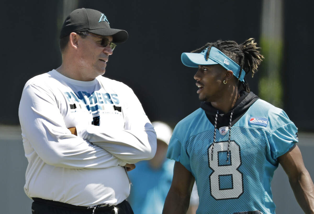 Carolina Panthers head coach Ron Rivera, left, talks with Austin Duke (8), who has clearly benefited from a year in an NFL strength and conditioning program, during the NFL football team's rookie camp on Friday.