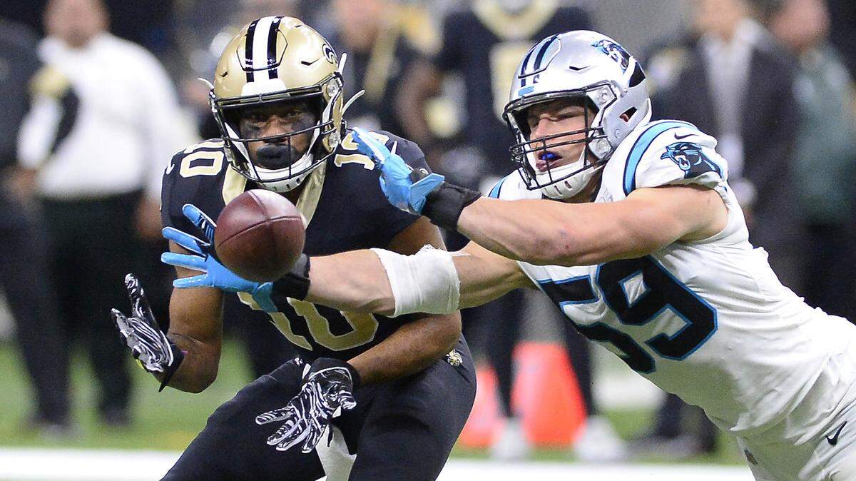 Carolina Panthers middle linebacker Luke Kuechly (59) breaks up a pass intended for a New Orleans Saints wide receiver in the first game between the two teams this season.