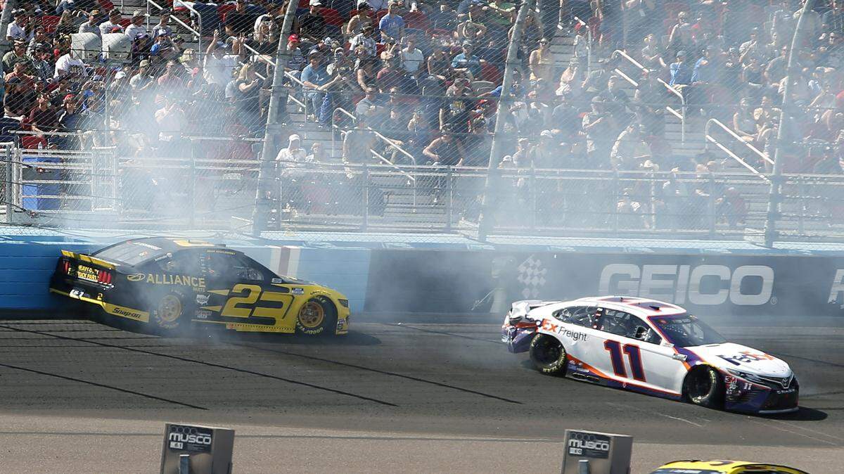 Brad Keselowski (2) and Denny Hamlin (11) crash during lap 65 of a NASCAR Cup Series auto race at Phoenix Raceway, Sunday, March 8, 2020, in Avondale, Ariz. (AP Photo/Ralph Freso)