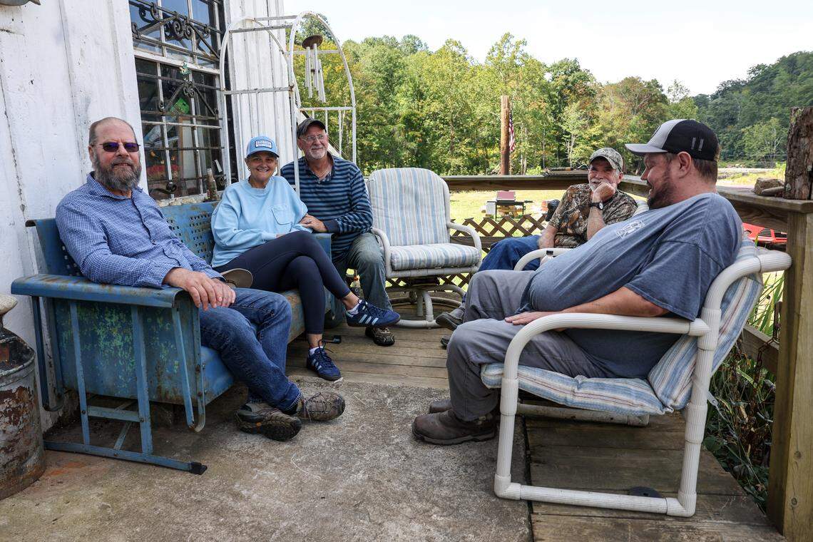 Danny Hensley, third from the left, is joined outside his Pensacola, N.C., general store by a group of friends who live in the area.