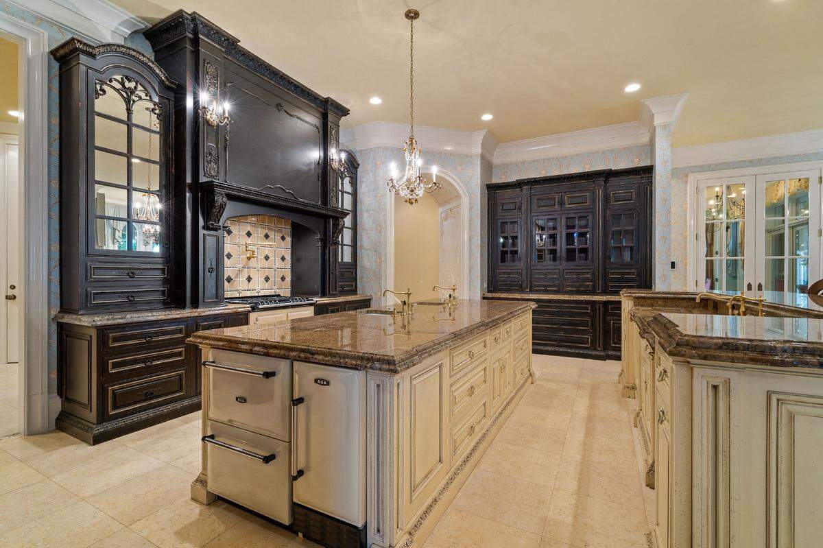 Habersham artisans made the gourmet kitchen, which includes double over-sized islands and granite counter tops, and an adjacent walk-in chef’s pantry.