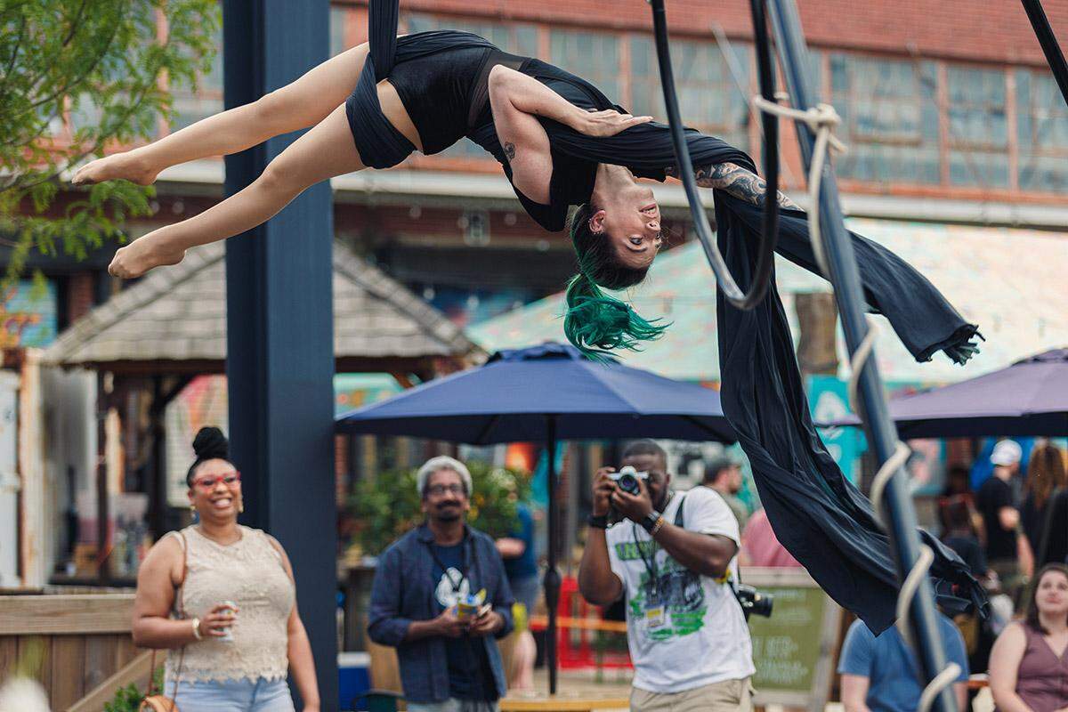 You never know what you might encounter at BOOM Charlotte, like an Aerial CLT performance, as seen at BOOM Charlotte 2022.