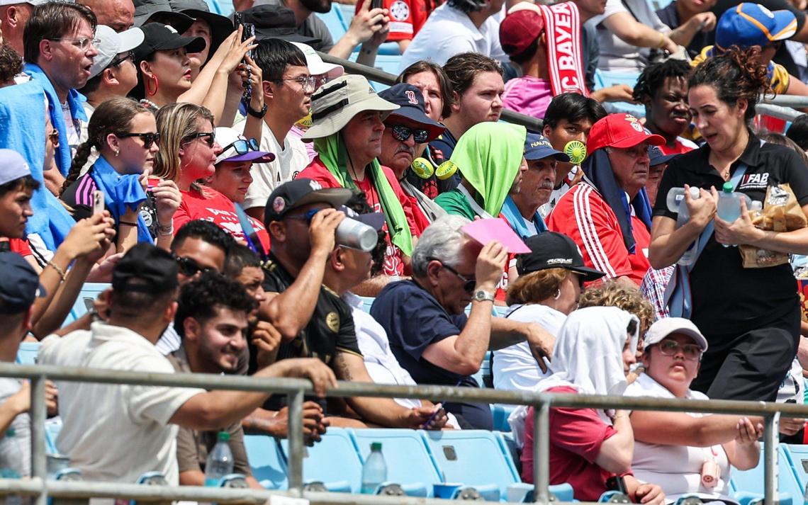 Fans keep cool on a scorching afternoon with portable fans, hats, towels on their heads and bottles water during the match between S.L. Benfica and Bayern München during the FIFA Club World Cup at Bank of America Stadium in Charlotte, NC on Tuesday, June 24, 2025.