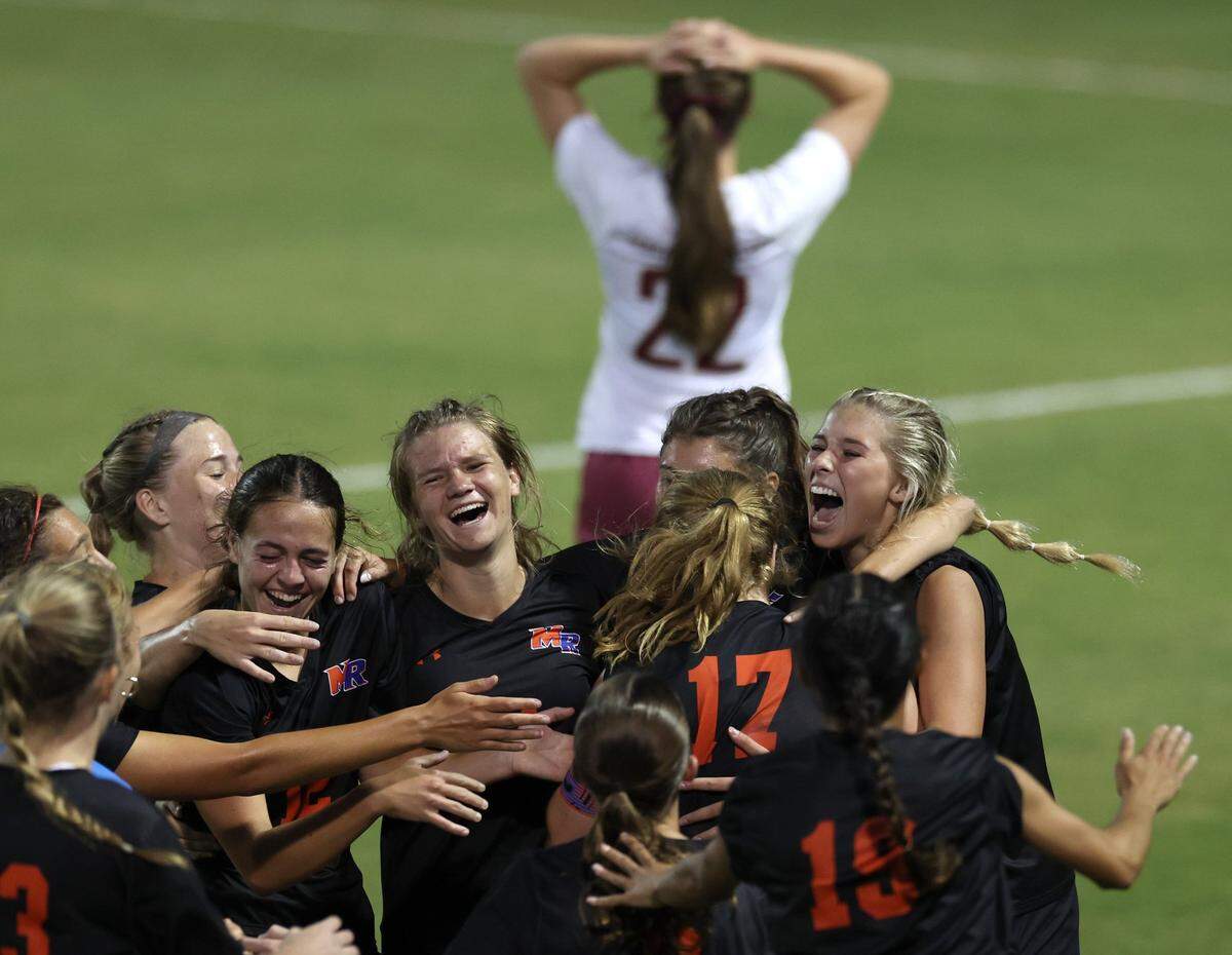Marvin Ridge celebrates their 2-1 victory over Wilmington Ashley of the NCHSAA 4A state final game at the Matthews Sportsplex in Matthews on Friday, May 31, 2024.