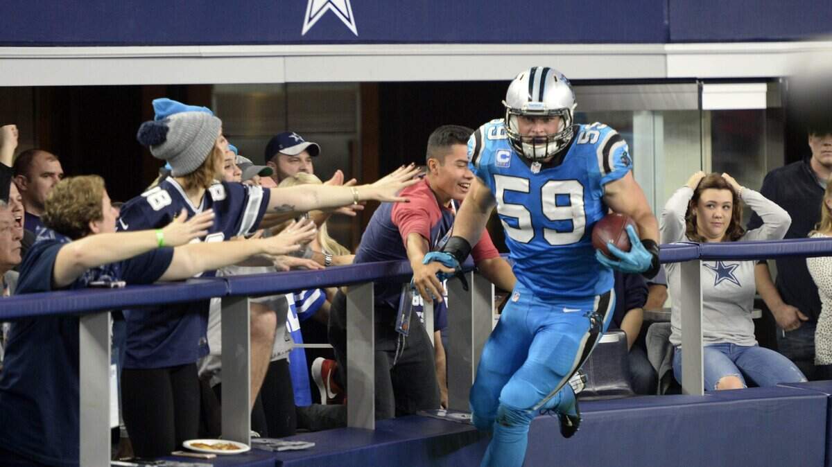 Dallas Cowboys fans react to Carolina Panthers’ Luke Kuechly (59) after scoring a touchdown after intercepting a Dallas Cowboys’ Tony Romo (9) pass in the second quarter at AT&T Stadium on Thursday, November 26, 2015. The Panthers led 23-3 at halftime.