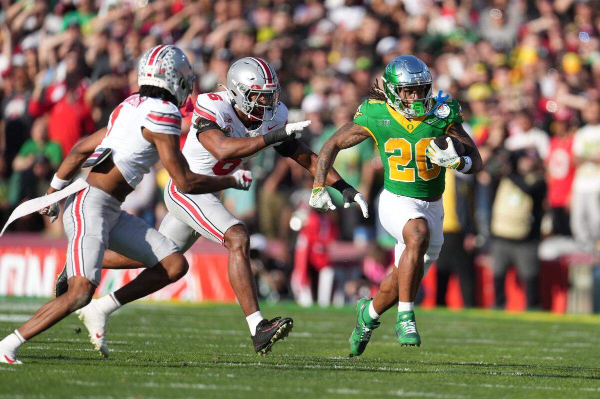 Jan 1, 2025; Pasadena, California, USA; Oregon Ducks running back Jordan James (20) carries the ball against Ohio State Buckeyes safety Sonny Styles (6) and cornerback Davison Igbinosun (1) during a CFP quarterfinal at Rose Bowl Stadium. Mandatory Credit: Kirby Lee-Imagn Images