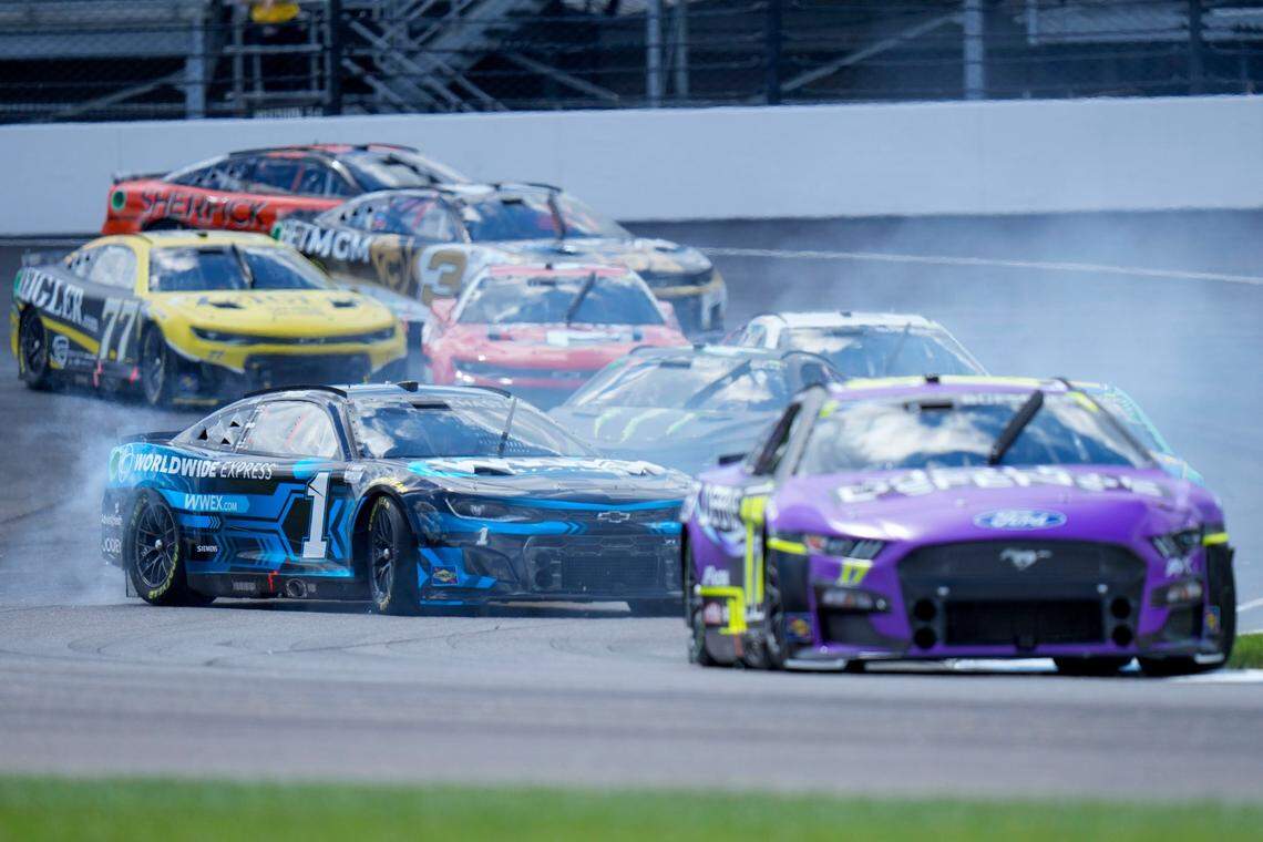 Ross Chastain (1) gets sideways in Turn 1 early in the running of the NASCAR Cup Series auto race at Indianapolis Motor Speedway, Sunday, July 31, 2022, in Indianapolis. (AP Photo/AJ Mast)