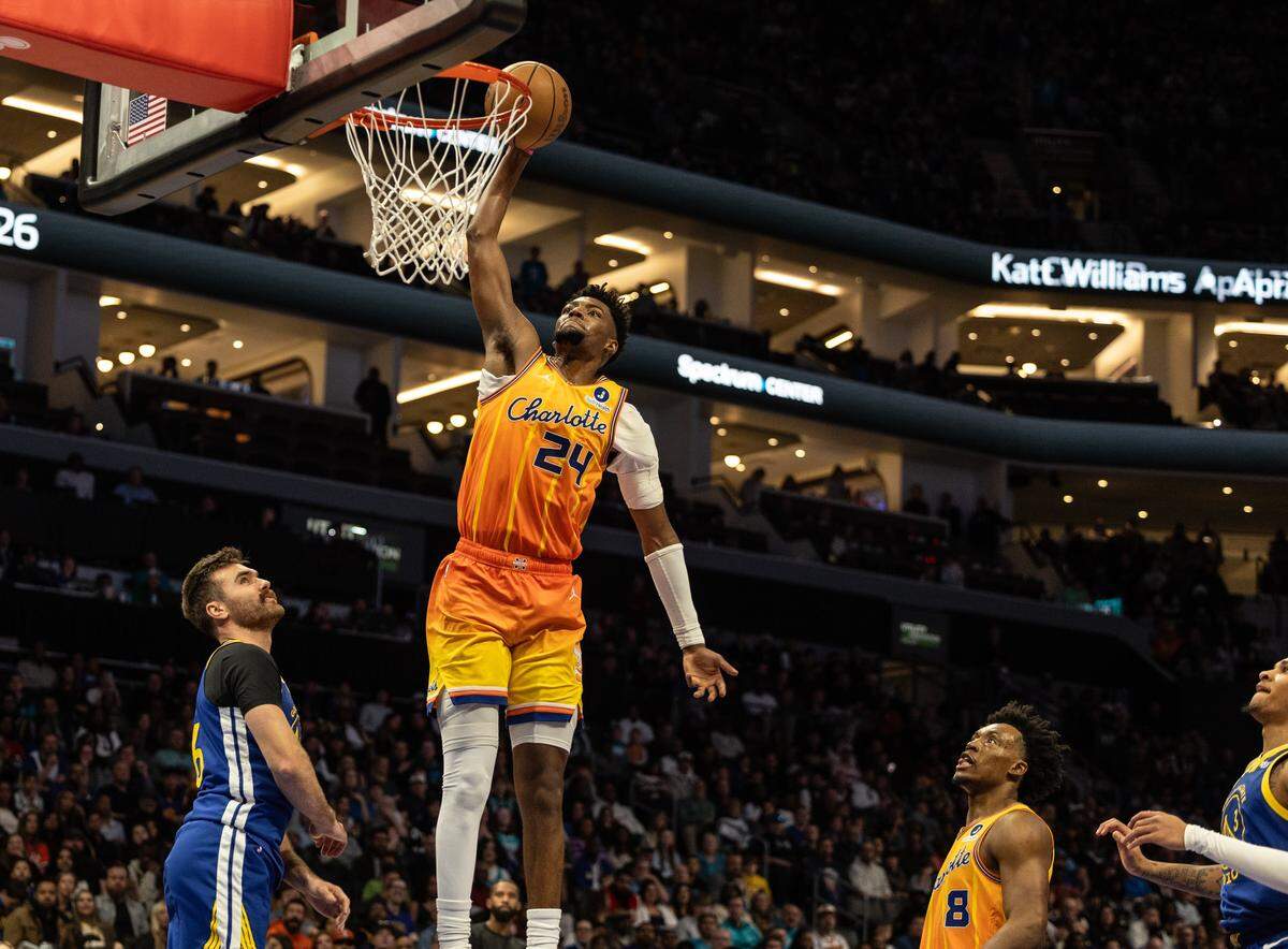 Charlotte Hornets forward Brandon Miller dunks against the Golden State Warriors at the Spectrum Center in Charlotte, N.C., on Wednesday, December 31, 2025.