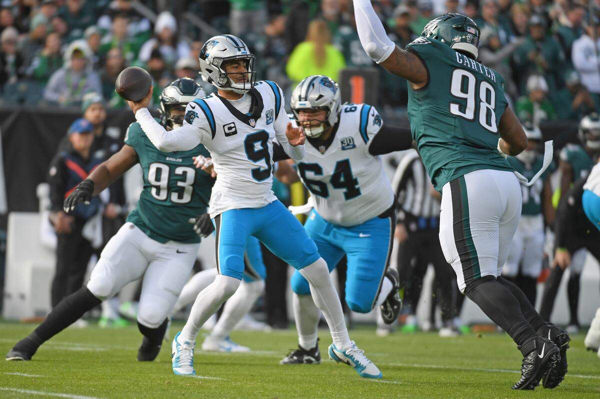 Dec 8, 2024; Philadelphia, Pennsylvania, USA; Carolina Panthers quarterback Bryce Young (9) throws a pass under pressure by Philadelphia Eagles defensive tackle Jalen Carter (98) during the first quarter at Lincoln Financial Field. Mandatory Credit: Eric Hartline-Imagn Images