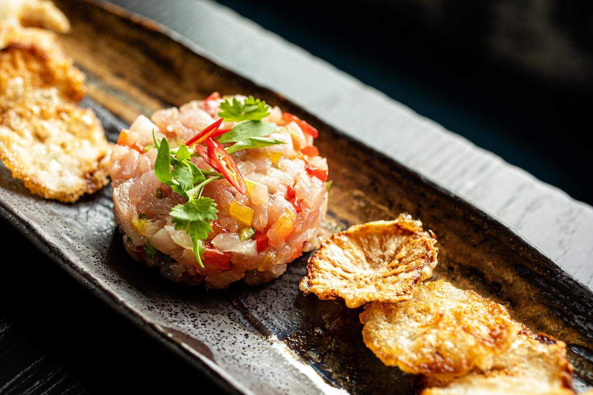 Dine with views of the city at Mizu, featuring dishes prepared with ancient Japanese cooking techniques.