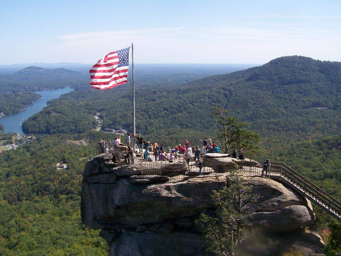 This popular view of Chimney Rock, and Lake Lure behind it, as seen from the Opera Box, a nearby vantage point in the park.