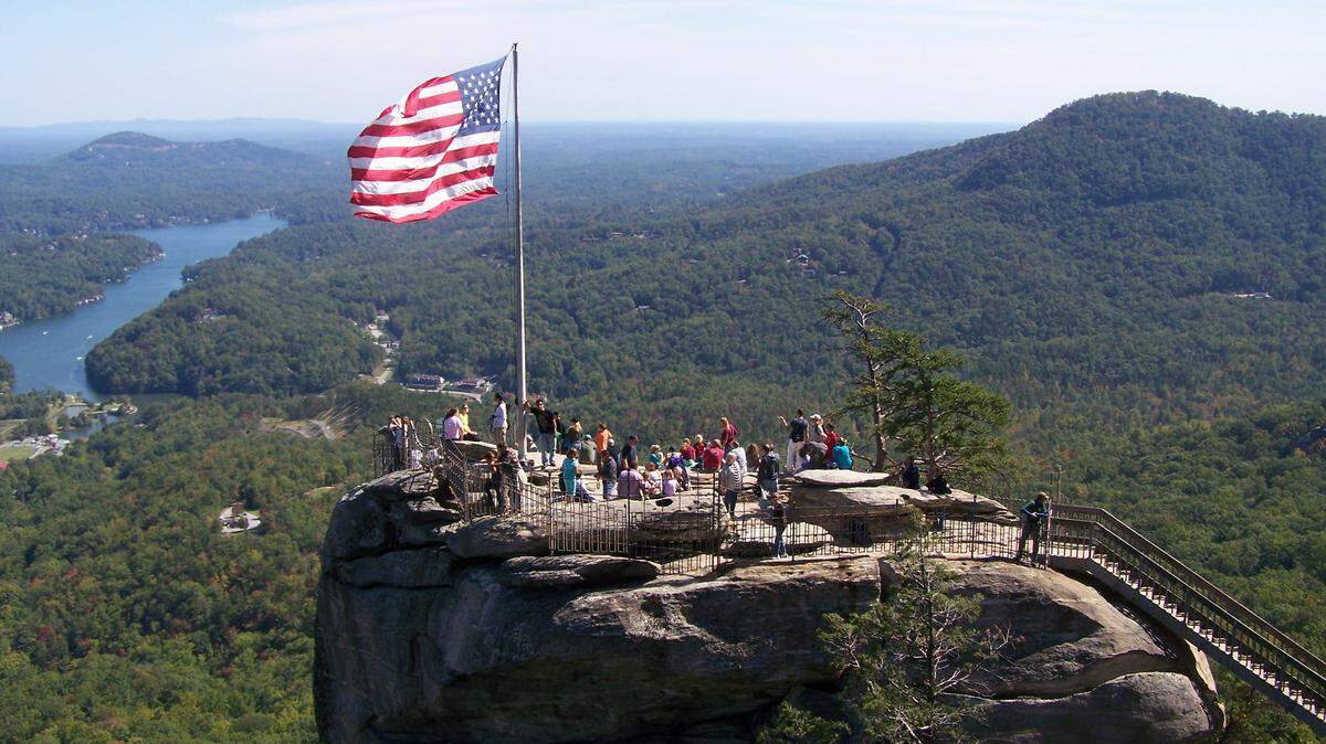 This popular view of Chimney Rock, and Lake Lure behind it, as seen from the Opera Box, a nearby vantage point in the park.