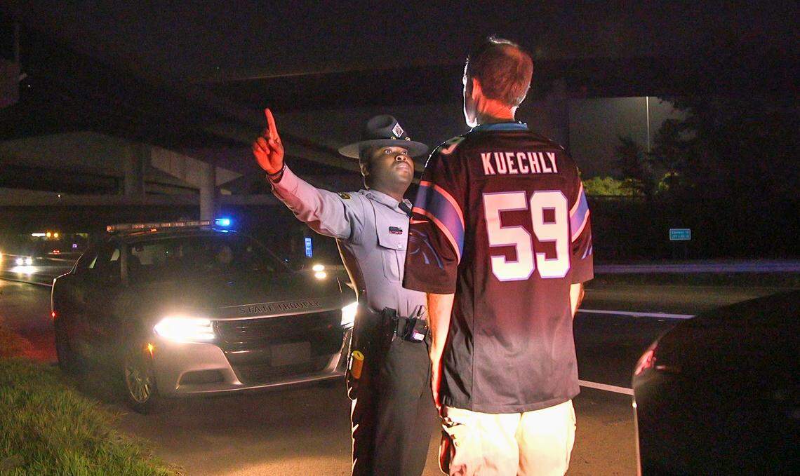 N.C. Highway Patrol Trooper Charles Montgomery conducts a field sobriety test on a driver after the Aug. 29 Carolinas Panthers game in Charlotte.