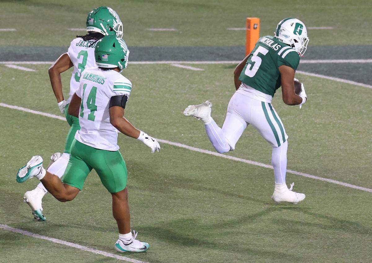Charlotte 49ers wide receiver Javen Nicholas, right, breaks free of North Texas defenders Evan Jackson and Quinton Hammonds for a touchdown during action on Friday, October 24, 2025 at Jerry Richardson Stadium.