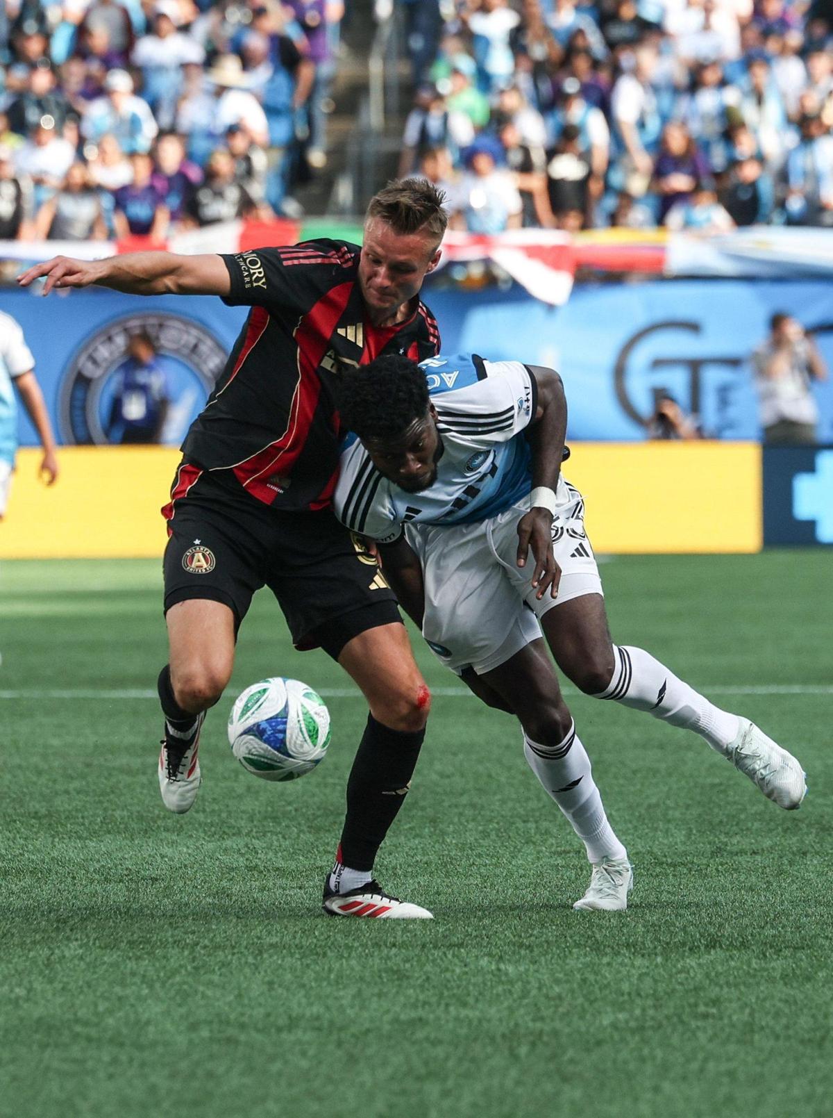 Charlotte FC’s Patrick Agyemang, right, leans into Atlanta United’s Stian Gregersen during the match at Bank of America Stadium in Charlotte, NC on Saturday, March 1, 2025.