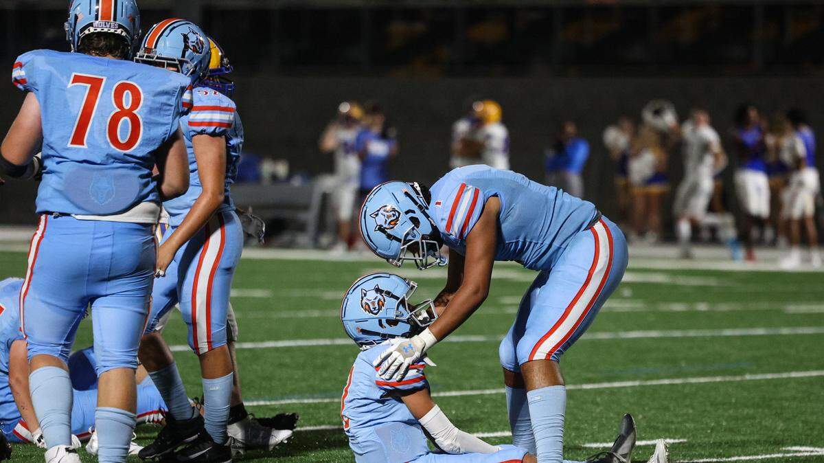 Ballantyne Ridge’s Justin Rodela, right, consoles teammate Ryder Polston, after a loss during the team’s first game of the season against Fort Mill on Friday, August 23, 2024. Ballantyne Ridge lost to Fort Mill, 56-0.