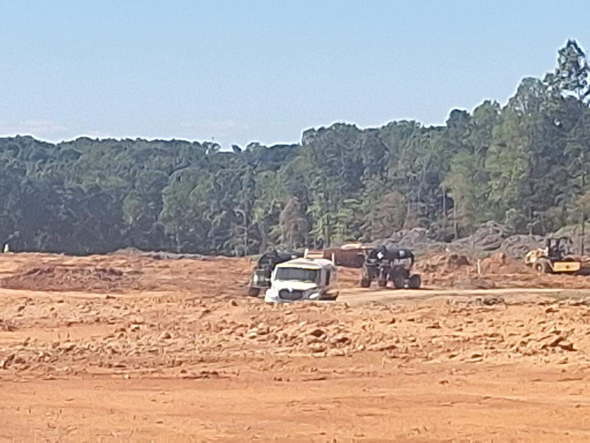 With a front-end loader, crews lifted large pieces of what will be the underground drainage system onto an 18-wheel flat bed truck at U.S. 21 when the Observer visited the site on Sept. 9. Work on Norman Village Road is 25% complete, Mooresville spokesperson Rika White said recently.