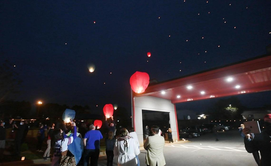 Lighted prayer lanterns are released skyward in honor of Jamie Seitz, beloved Lincoln Charter School teacher and coach who died of COVID-19, during a memorial service at the school in Denver, NC on Wednesday, December 30, 2020.
