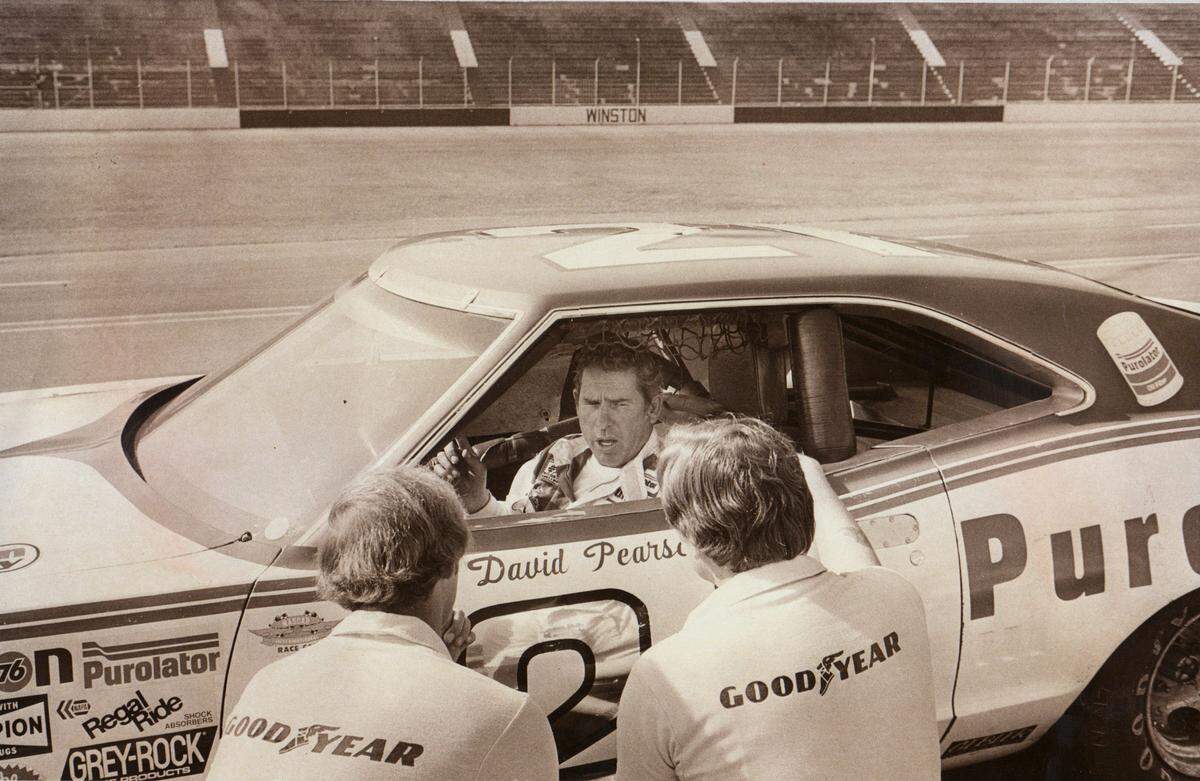 David Pearson talks with his crew after completing a test run in 1975. Although Pearson never once ran a full season in NASCAR’s top series, he still won the overall series championship three times.