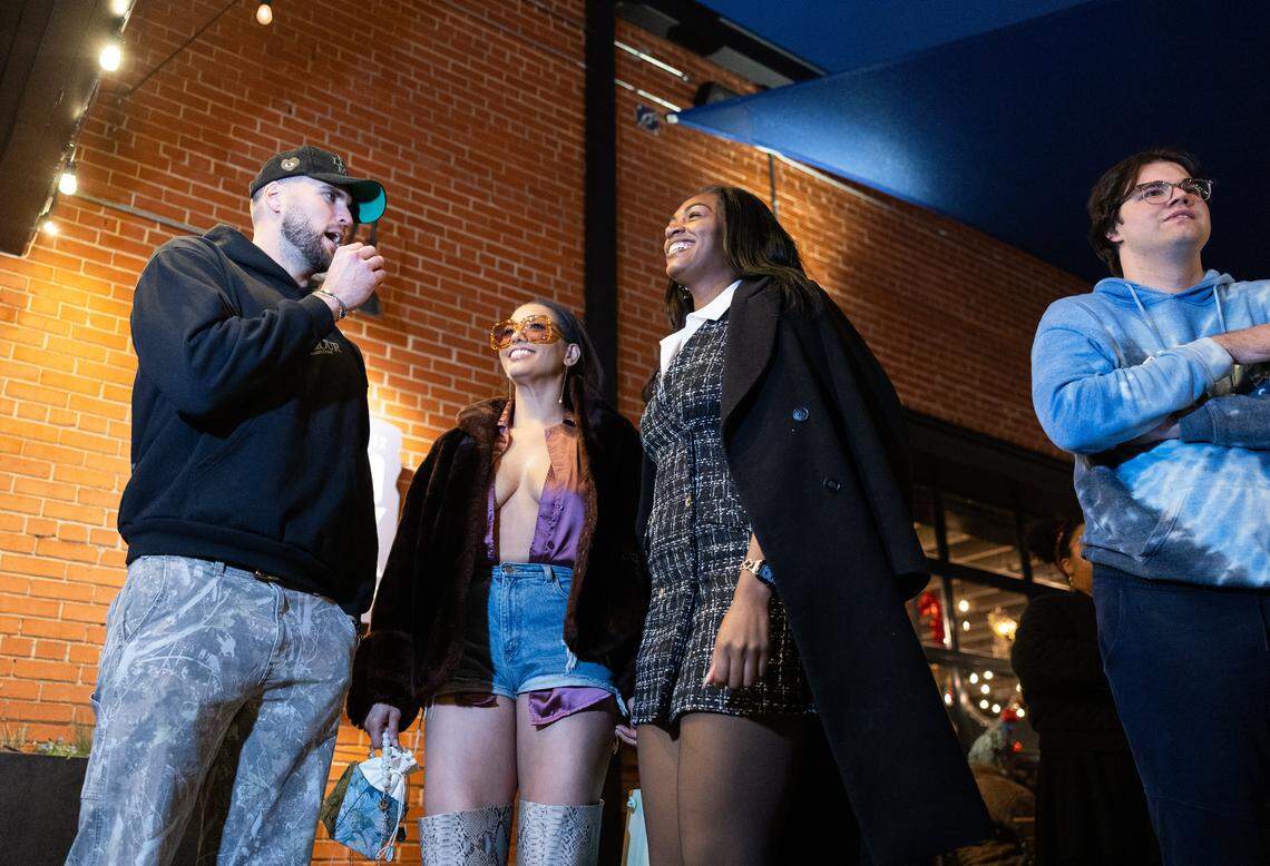 The 6-foot-9-inch, Tall Tour host, Tyler Bergantino, left, interviews tall women during the Tall Tour event at Brewers At 4001 Yancey in Charlotte, N.C., on Saturday, December 6, 2025.