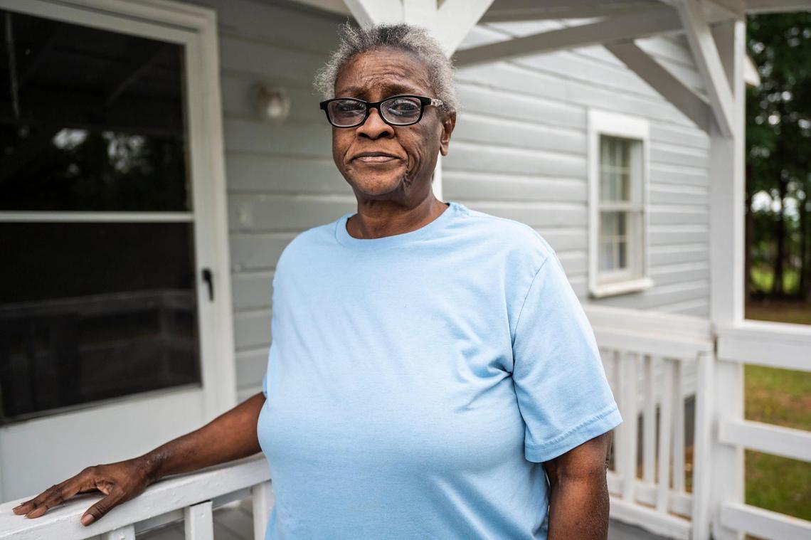 Dora Robinson outside of her home in the Sterling community on Tuesday, May 24, 2022 in Charlotte. Like most residents affected by the developer’s purchase, Robinson, who shares the house with her nine-year-old granddaughter, Miyelle, a third grader at Sterling Elementary, is unsure of where she will go once she has to leave her home.