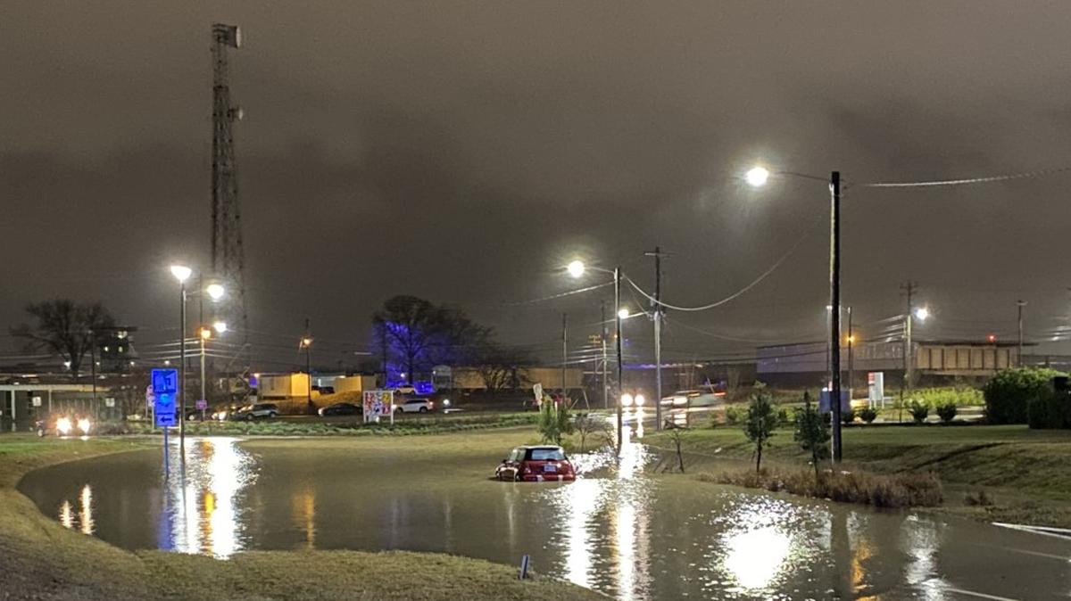 In this image from WBTV, a car finds itself stuck in floodwater at North Tryon and Graham street near uptown Charlotte, NC, on Monday, Jan. 3, 2022. Heavy rain and strong wind gusts created power outages throughout the region.