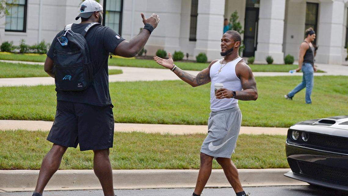 Carolina Panthers tackle Taylor Moton, left and linebacker Denzel Perryman, right, greet one another after arriving at their dormitory on the campus of Wofford College in Spartanburg, SC on Tuesday, July 27, 2021. The Panthers will hold their first training camp practice on Wednesday, July 28, 2021.