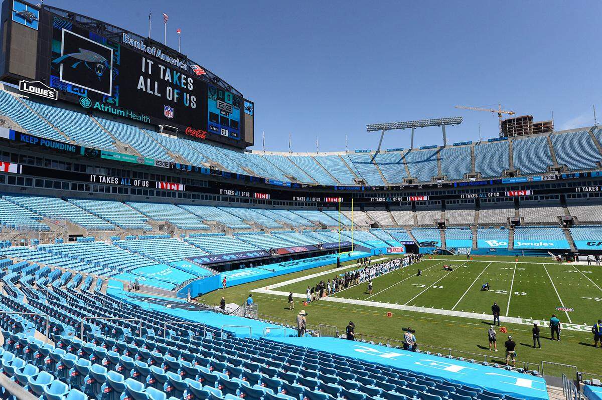 The Carolina Panthers stand in an end zone of Bank of America Stadium listening to the song Lift Every Voice and Sing on Sunday, September 13, 2020 at Bank of America Stadium in Charlotte, NC. The Carolina Panthers will host the Las Vegas Raiders in NFL action with no fans in attendance due to the COVID-19 pandemic.