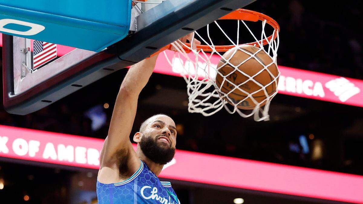 Charlotte Hornets forward Cody Martin (11) slam dunks the ball over Dallas Mavericks defense during a game at Spectrum Center in Charlotte, N.C., Saturday, March 19, 2022. Charlotte beat Dallas 129-108.
