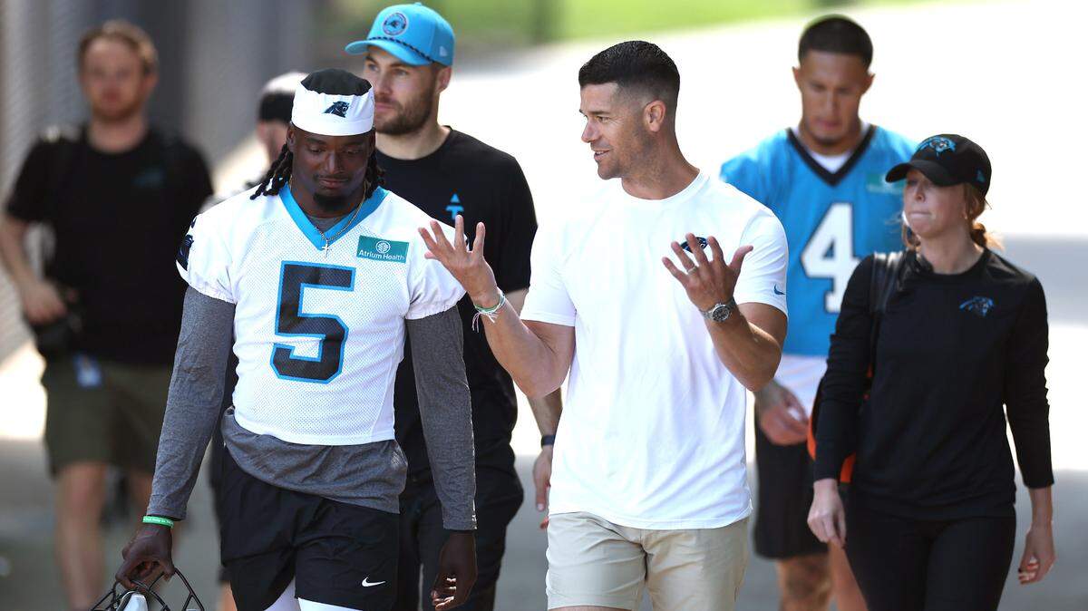 Carolina Panthers head coach Dave Canales, right, talks with cornerback Keion Corseen, left, as they walk to the team’s rookie minicamp practice on Friday, May 9, 2025.