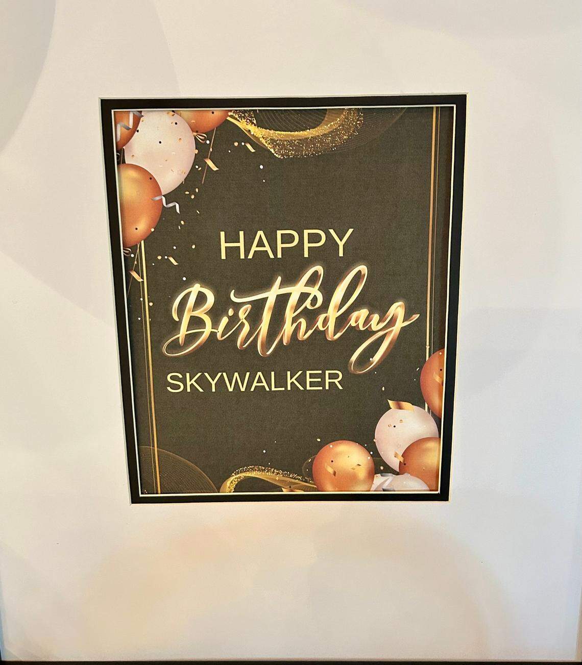 A sign at the 70th birthday party of N.C. State legend David Thompson referenced his nickname “Skywalker.”