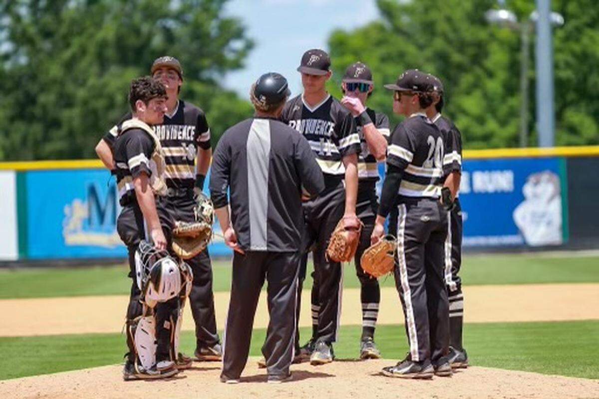 Providence Panthers head coach Danny Hignight gives his team a pep talk on the field