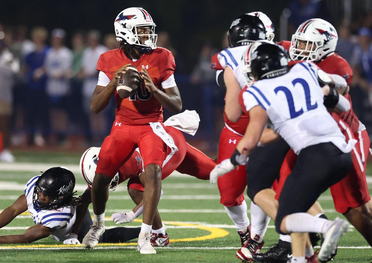 As the Charlotte Christian defense rushes, Providence Day Chargers quarterback Zaid Lott, center, stands in the pocket looking to pass during action on Friday, November 8, 2024 at Providence Day School.