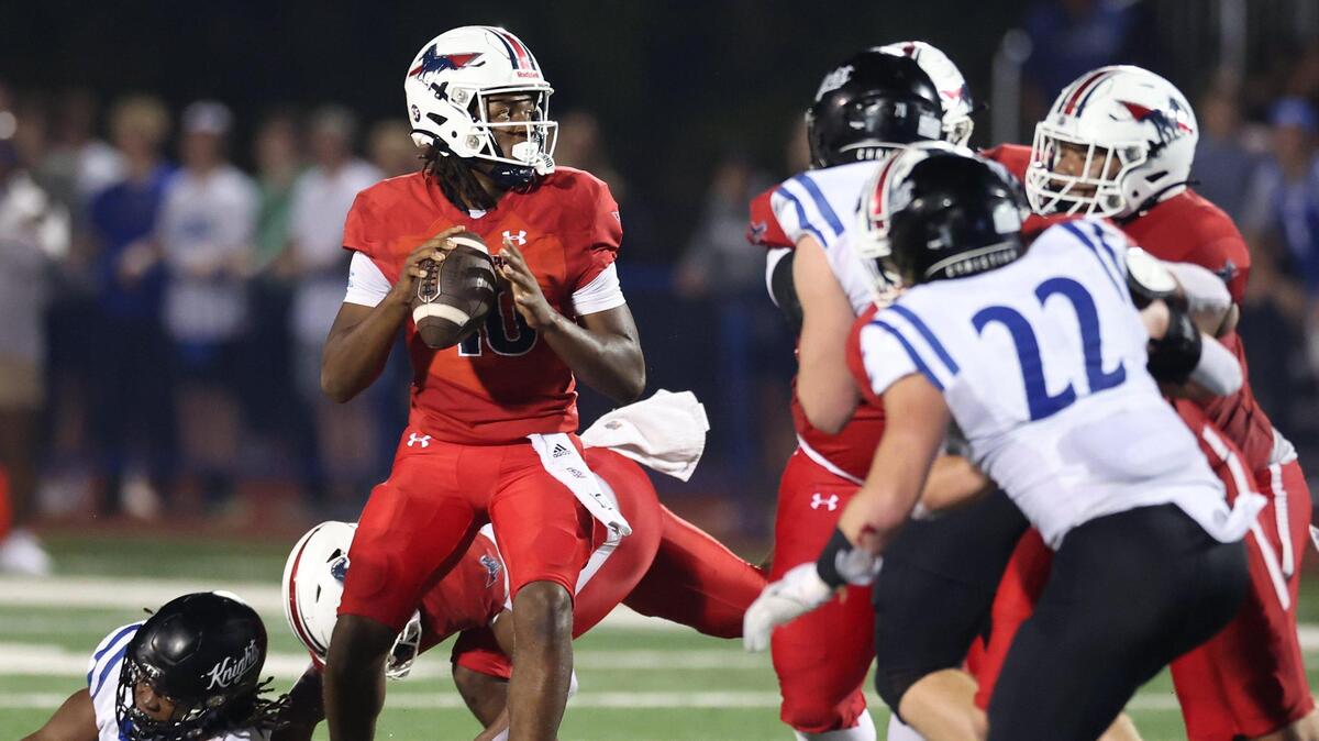 As the Charlotte Christian defense rushes, Providence Day Chargers quarterback Zaid Lott, center, stands in the pocket looking to pass during action on Friday, November 8, 2024 at Providence Day School.