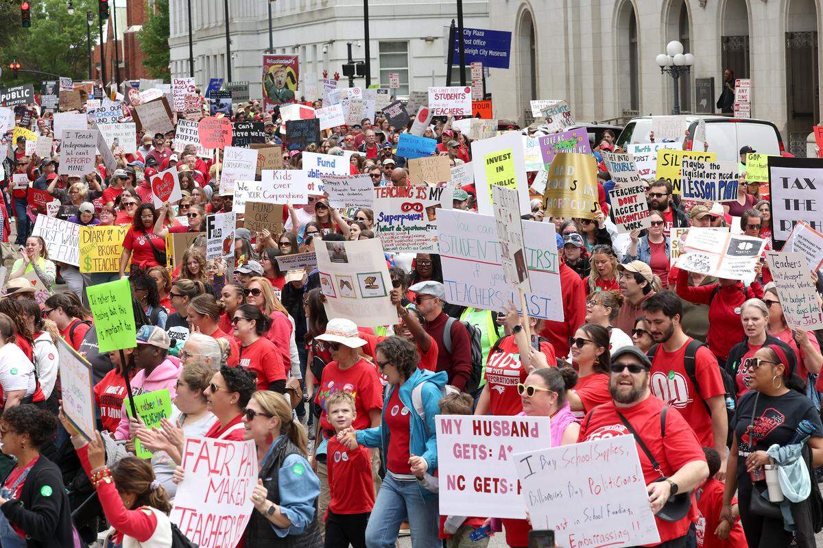 Teachers march through downtown Raleigh, NC on Friday, May 1, 2026 during a mass rally to protest the need for more funding for public schools.