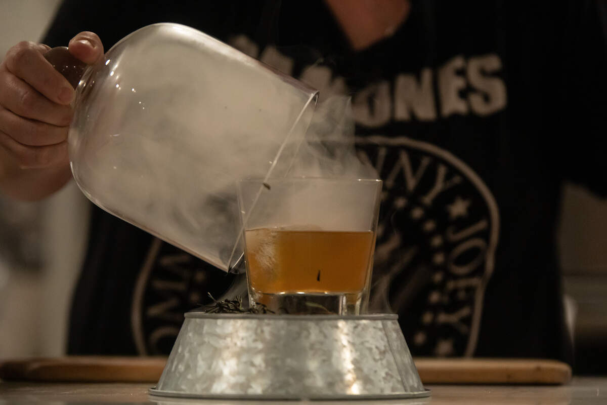 The Paratrooper at The Artisan’s Palate includes housemade Fig Bourbon, rosemary simple syrup, bitters and smoked rosemary.